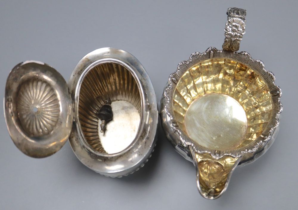 A George IV silver cream jug, London 1823 and an oval half-fluted tea caddy, approx 15oz